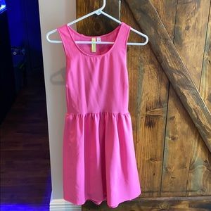 Pink mini dress with scalloped open back.